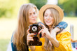 © Полина Власова - Cheerful girls in the cottage garden with vintage camera. Family and friends autumn fall holidays