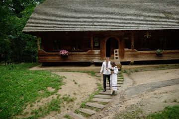  Beautiful bride and groom in the ukrainian style are standing w