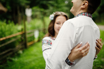  Beautiful bride and groom in the ukrainian style are standing w