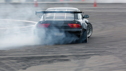 Motion blur car drifting, Professional driver drifting car on race track with smoking.