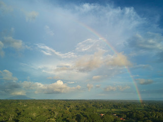 Wall Mural - Rainbow on blue cloudy sky