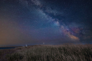 Wall Mural - vibrant milky way composite image over landscape of lighthouse