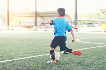 Young Asian football player in blue jersey between competition.