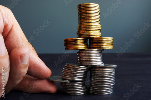 Cuadros en Lienzo Financial Stability concept. Man holding coin in the coins stack.