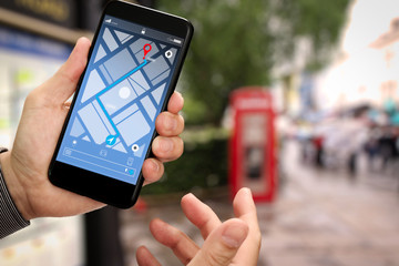 Poster - Close up of Tourist using GPS map navigation on smartphone application screen for direction to destination address in the city with travel and technology concept.