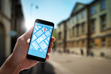 Poster - Close up of Tourist using GPS map navigation on smartphone application screen for direction to destination address in the city with travel and technology concept.