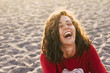 bright picture of laughing woman on the beach. backlight sunlight in nbackgroiund. beautiful young female model laugh like crazy. happiness and joyful concept for people in wanderlust
