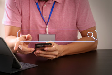 Aufkleber - businessman in pink t-shirt working with smart phone and digitl tablet computer on wooden desk in modern office