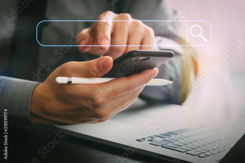 Cuadros en Lienzo close up of businessman working with mobile phone and stylus pen and laptop comp