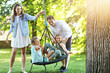 © Kalim - Joyful family having fun on playground