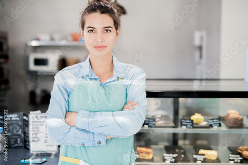 Fotografie, Obraz Waist up portrait of modern female shopkeeper posing confidently standing with a