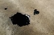 black dirty oil on concrete ground
