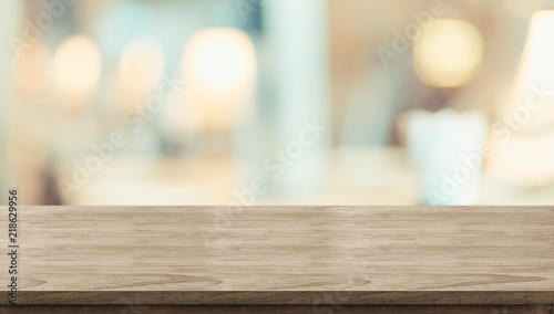 Zdjęcie: Empty rustic wood table and blurred soft light table in restaurant with bokeh background. product display template.Business presentation. Empty rustic wood table and blurred soft light table in restaurant with bokeh background. product display template.Business presentation.