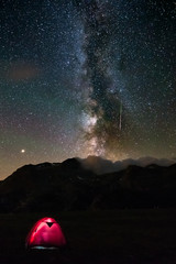 Wall Mural - meteor with green tail starry sky milky way. illuminated tent in the foreground, camping on the alps