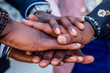 © yurakrasil - hands closeup of group black afro american friends men businessmen in stylish business suit, expensive wristwatch handshake teamwork .concept of successful business and good deal