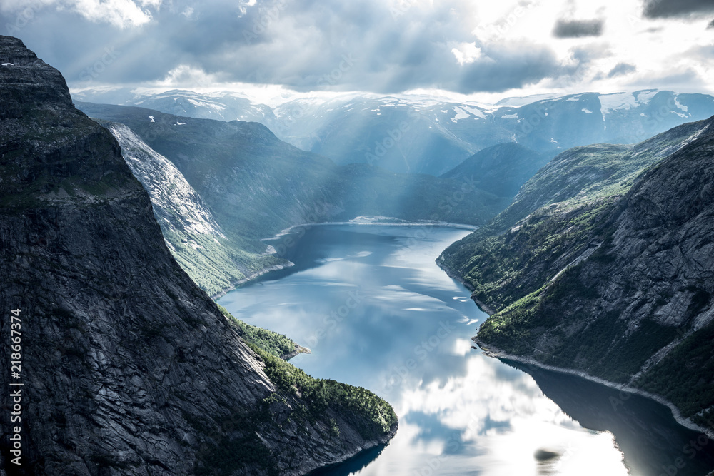 Beautiful fjord in Norway with amazing sun rays. View from the top - obrazy, fototapety, plakaty 