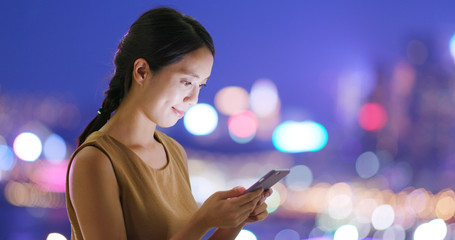 Canvas Print - Woman use of smart phone in city at night