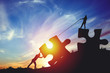 © fotomaximum - People silhouettes putting puzzle pieces together on sunlight background