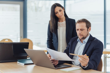 Two business colleagues working on a document