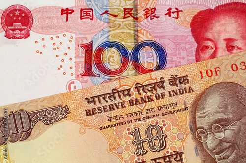 Fotografia, Obraz A close up image of a 100 Chinese yuan bank note with a 10 Indian Rupee bank not