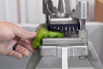 bell pepper being cut for meal prep at restaurant