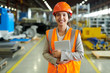 © Seventyfour - Waist up portrait of cheerful young woman wearing hardhat smiling happily looking at camera while enjoying work in production workshop, copy space