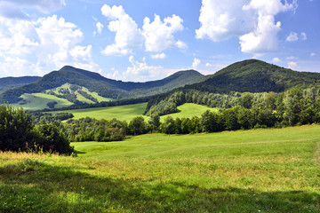 Beautiful summer landscape in the mountains with green meadows and forested hills, Low Beskids (Beskid Niski). 