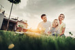 © Yakobchuk Olena - Low angle portrait of beaming bearded man talking with cheerful wife. She holding outgoing small girl. Basket with vegetables locating near them. Pleased couple with beaming kid during picnic concept
