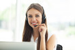 © opolja - Female customer support operator with headset and smiling.