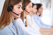 © rogerphoto - Call center. Beautiful cheerful smiling operator consulting clients with headset. Business concept of customer service