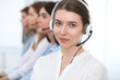 © rogerphoto - Call center. Beautiful cheerful smiling operator consulting clients with headset. Business concept of customer service