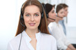 © rogerphoto - Call center. Beautiful cheerful smiling operator consulting clients with headset. Business concept of customer service