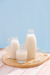 Wall Mural - Dairy products. Bottle with milk and glass of milk on wooden table