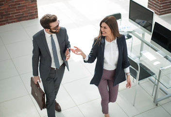 Wall Mural - business couple discussing business issues while walking around the office