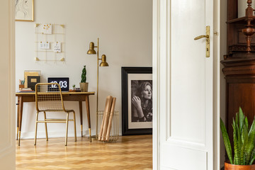 Wall Mural - Real photo of an elegant home office interior with golden accents. View through opened door