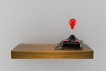 Canvas Print - Joystick on wooden shelf