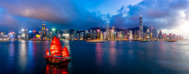 Fototapete - Panorama of Hong Kong City skyline with tourist sailboat at night. View from across Victoria Harbor HongKong.