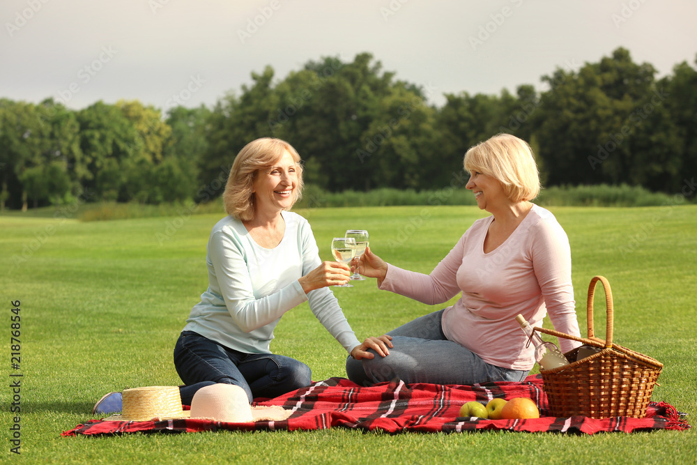 Mature women on a picnic in green park