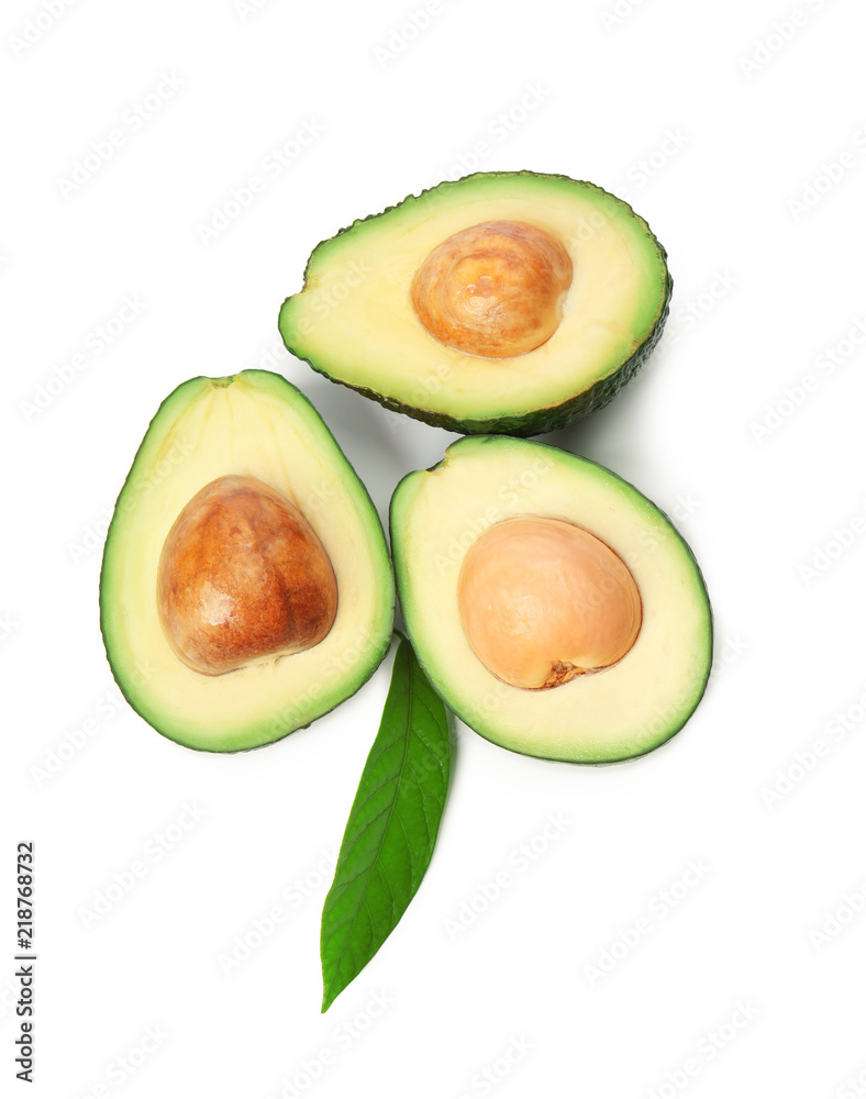 Halves of ripe avocados on white background