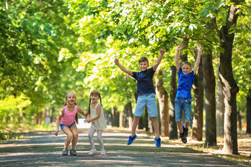 Canvas Print - Cute little children playing in green park