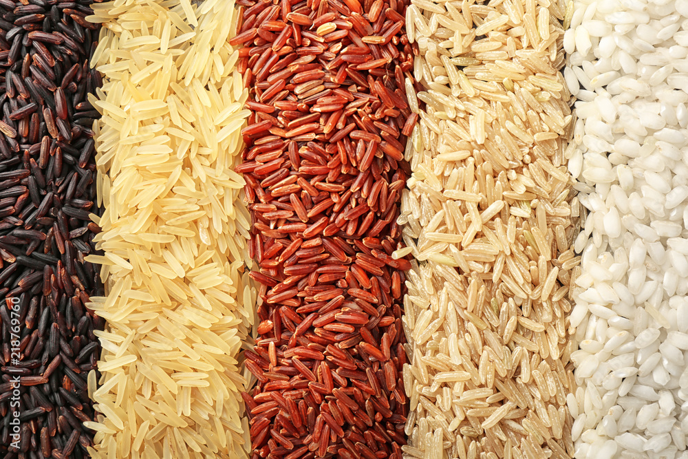 Different types of rice as background, closeup