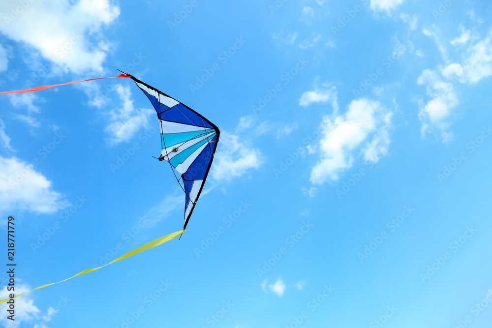 Colorful kite flying in blue sky