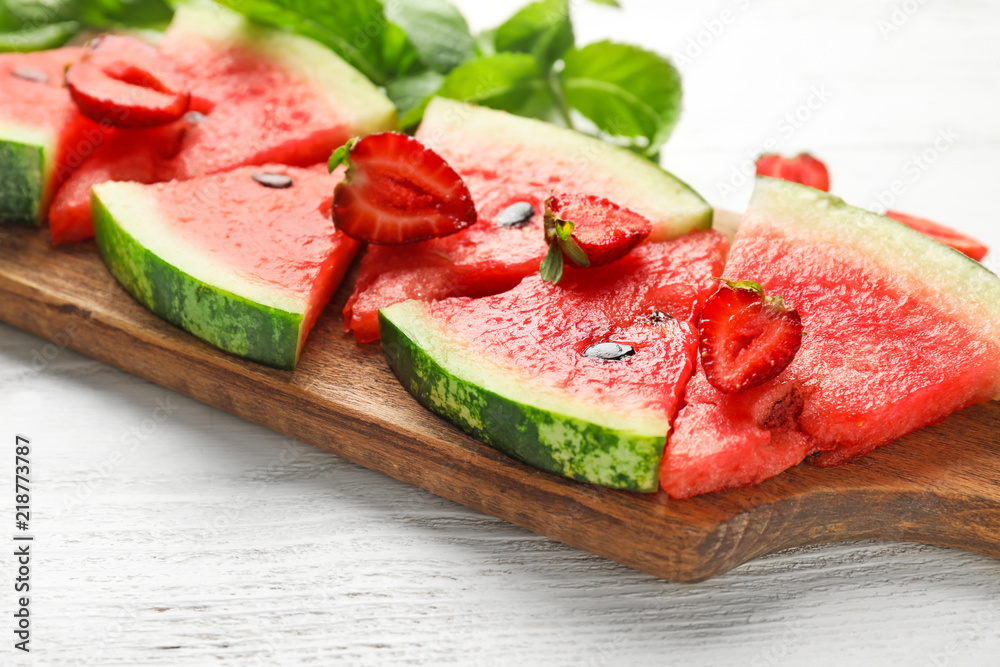 Sweet watermelon slices on wooden board, closeup