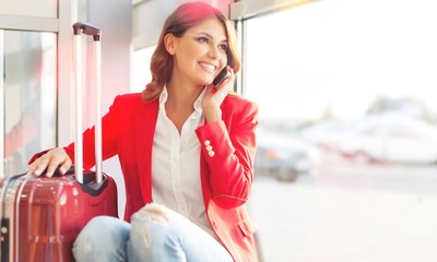 Wall Mural - Airport business woman on smart phone at gate waiting in