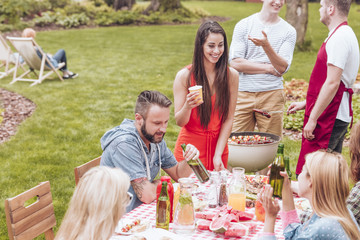 Friends at a garden BBQ party during summer school brake.