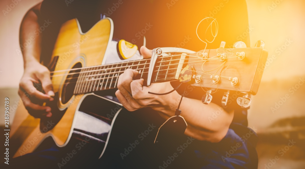 hand playing acoustic guitar, close up on musical instrument Relaxation Music sound hobby passion concept. - obrazy, fototapety, plakaty 