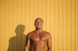© ADDICTIVE STOCK - Muscular older man poses in yellow cabin background.