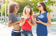 © Prostock-studio - Happy girls with take away coffee outdoors