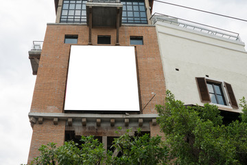 Blank billboard on red brick building.