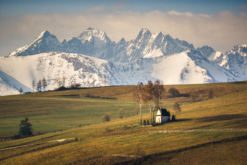 Wall Mural - Landscape with a chapel and snow-covered Tatra Mountains in Kacwin, Malopolskie, Poland